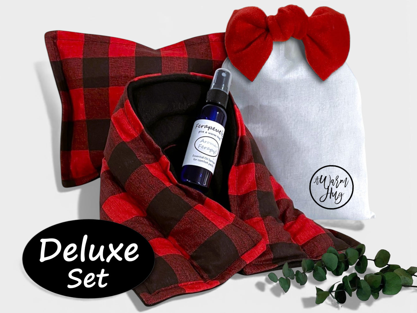 Red and buffalo plaid heated neck wrap with lavender spray bottle, bow, and 'Deluxe Set' label on a white background