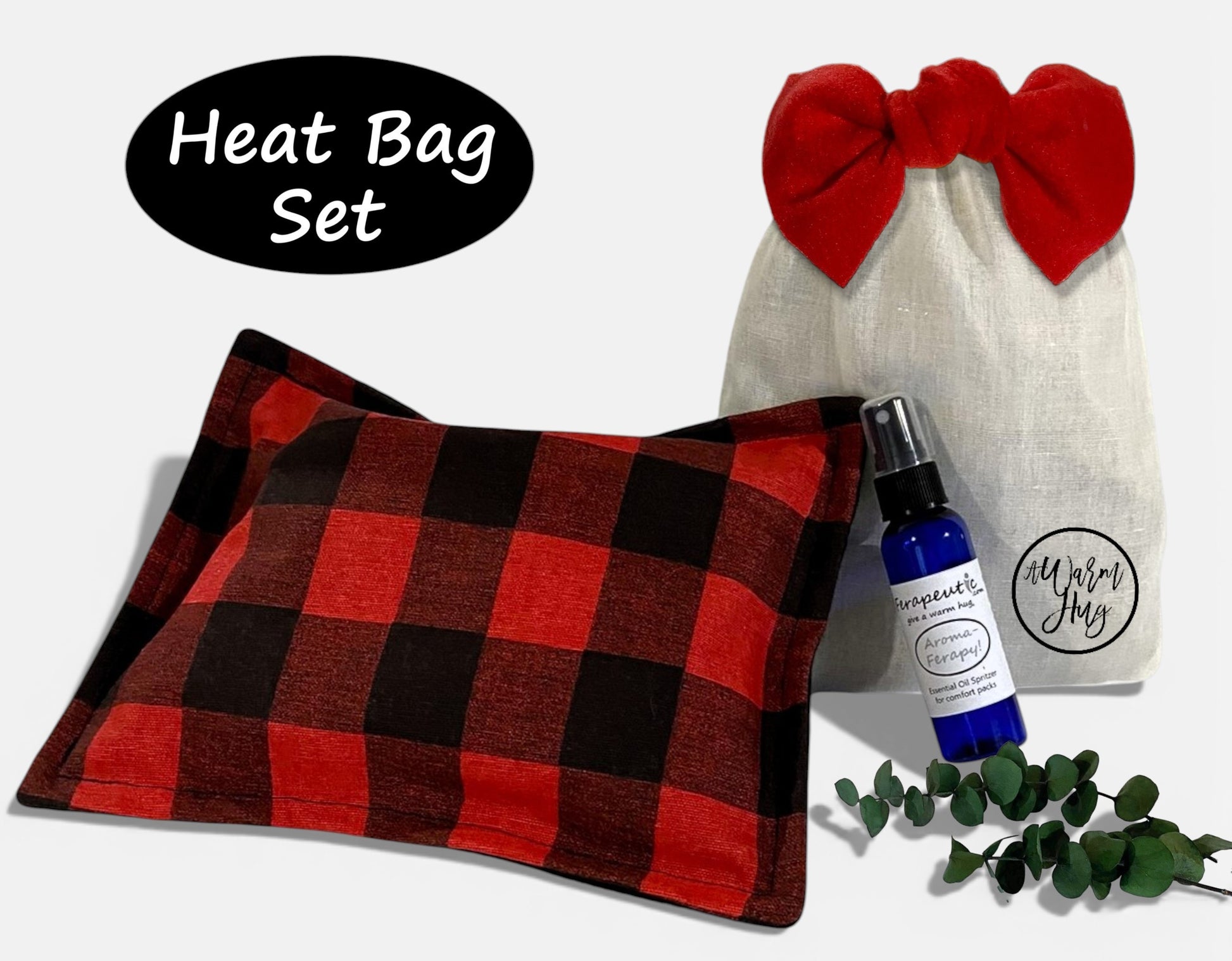 Heat bag set with red and black checkered heat pack, white gift bag with red bow, and bottle of essential oil on a white background.