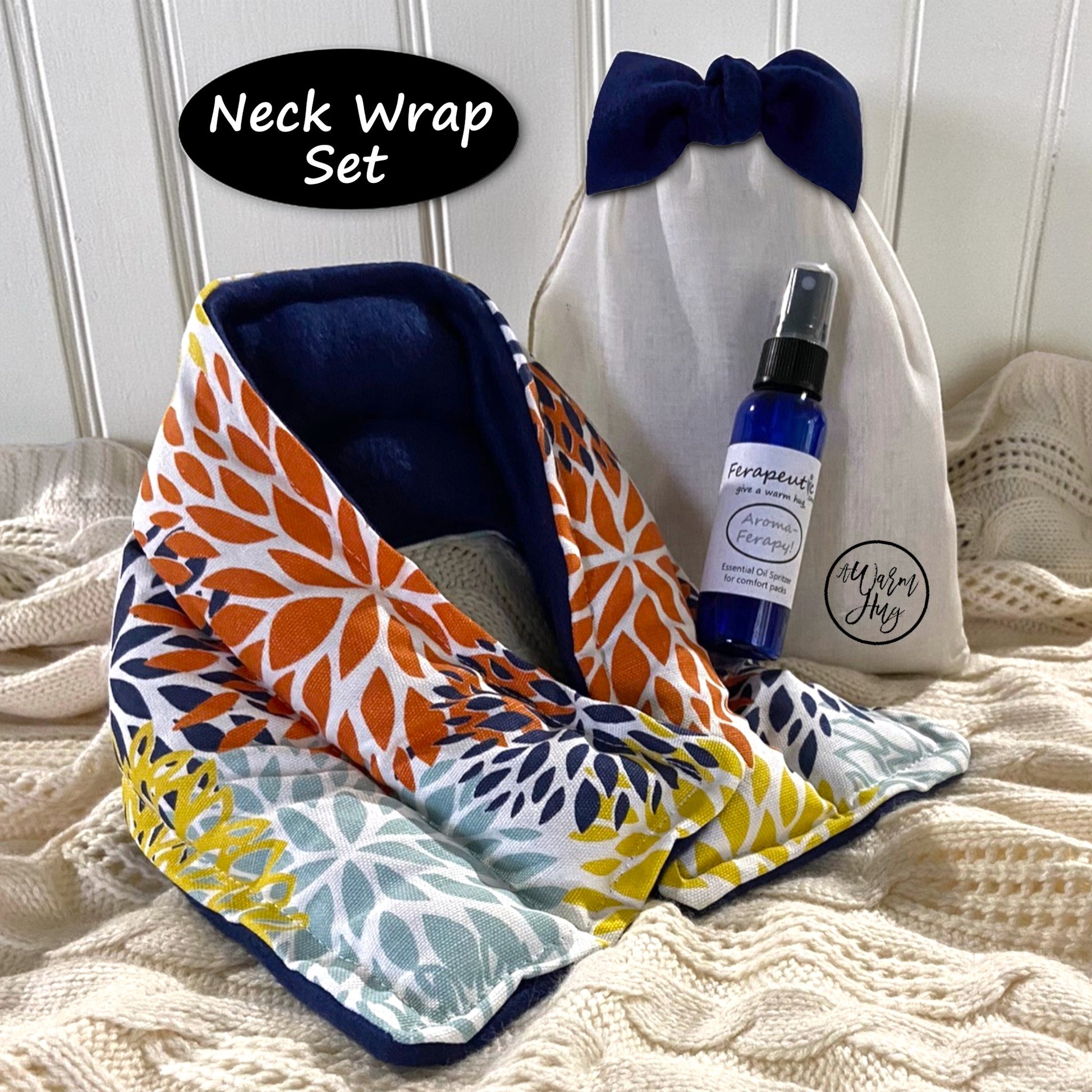 Neck wrap set with a bottle of lavender spray and cotton gift bag on a textured surface
