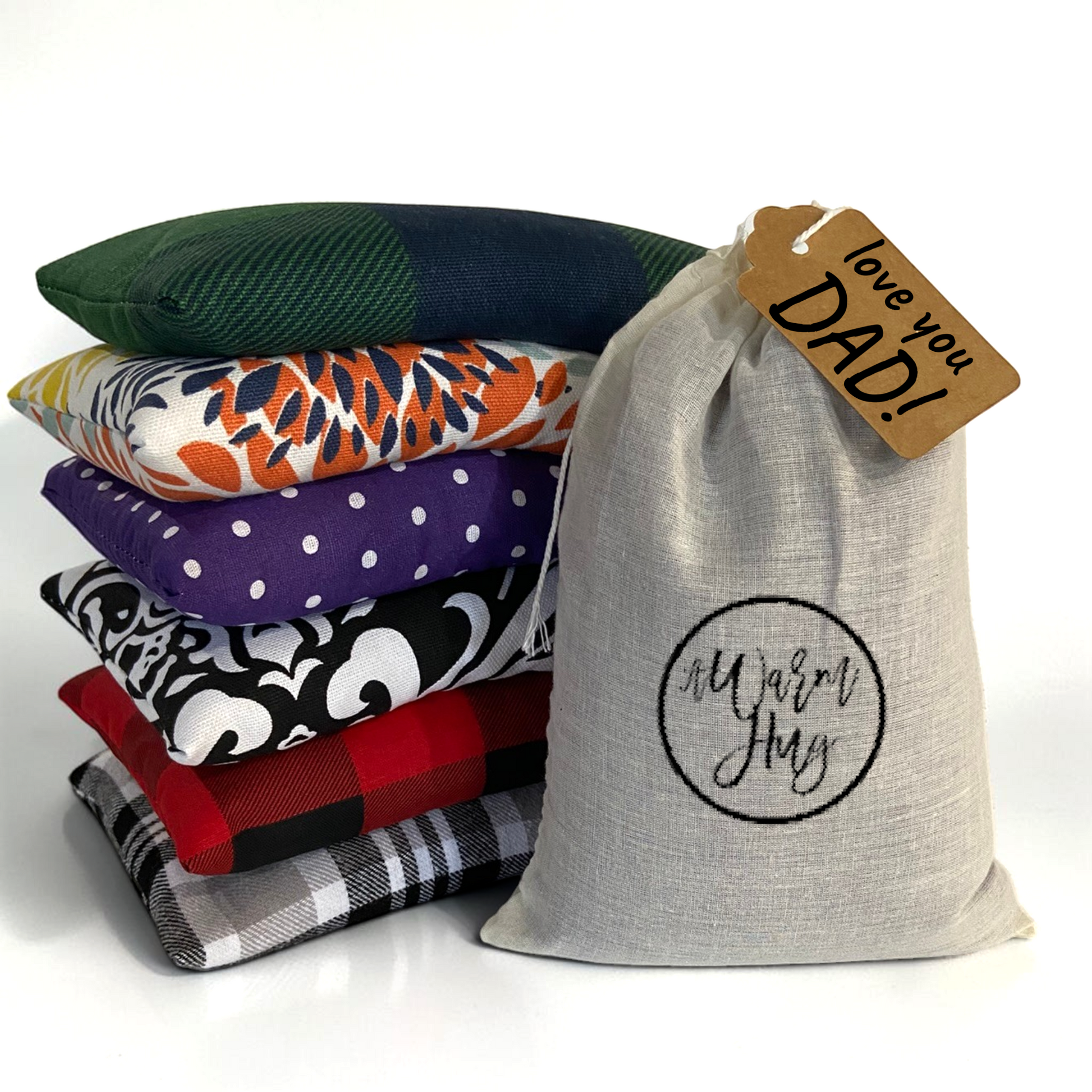 Stack of comfortable small heat packs with warm hug gift bag and gift tag that reads, 'love you Dad!'