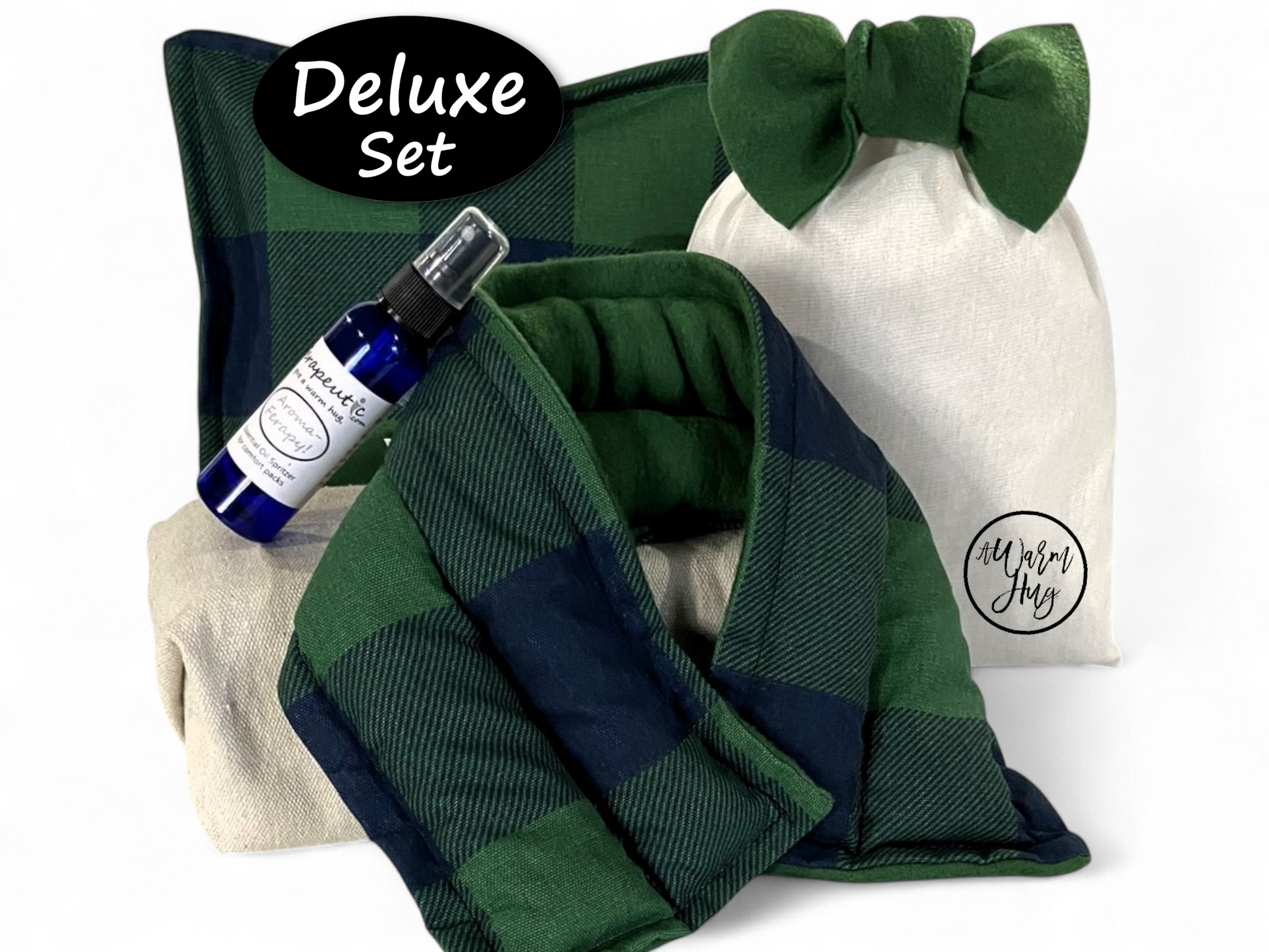 Deluxe set with green plaid hot cold packs, essential oil lavender spray bottle, and gift pouch with green bow on a white background