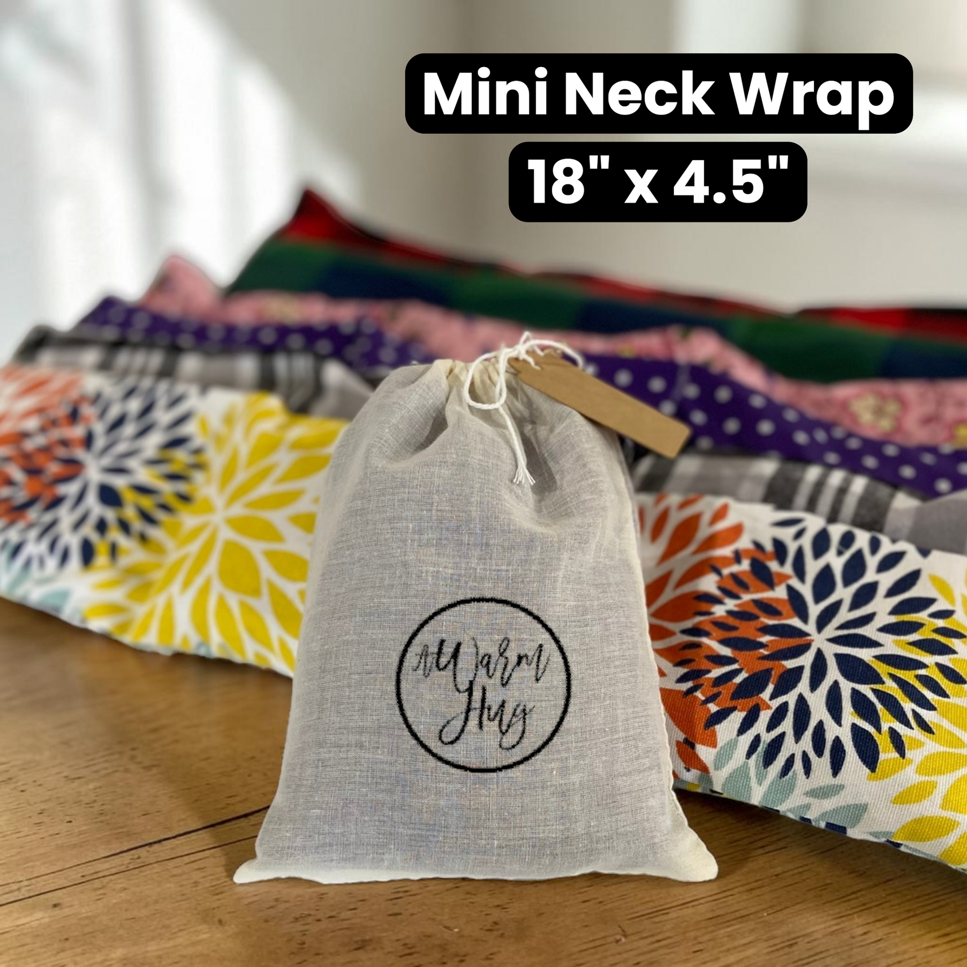 Row of microwavable neck wraps with gift bag and sizing information