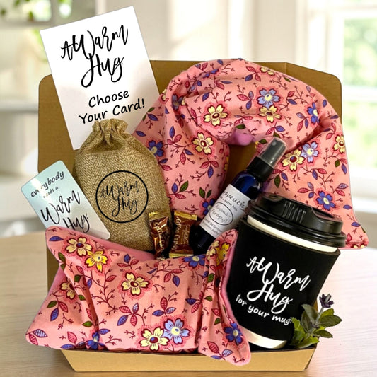 Gift basket with floral items and 'Warm Hug' branding on a blurred background