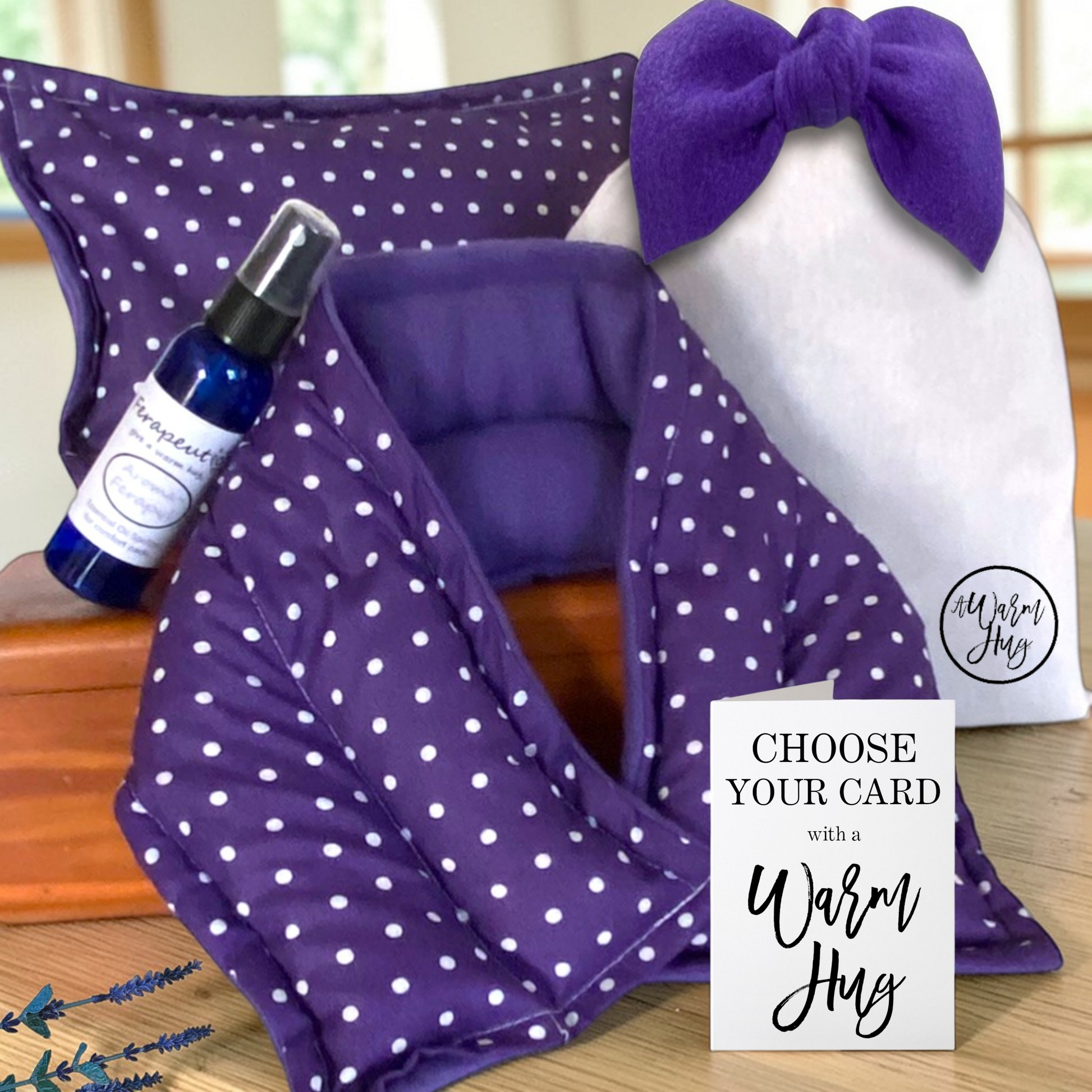 A Warm Hug gift set in purple polka dot fabric, includes microwavable neck wrap, heat bag, aromatherapy spray and a cotton gift bag with big purple bow.  Also includes a gift card that indicates you can choose the occasion for the gift.