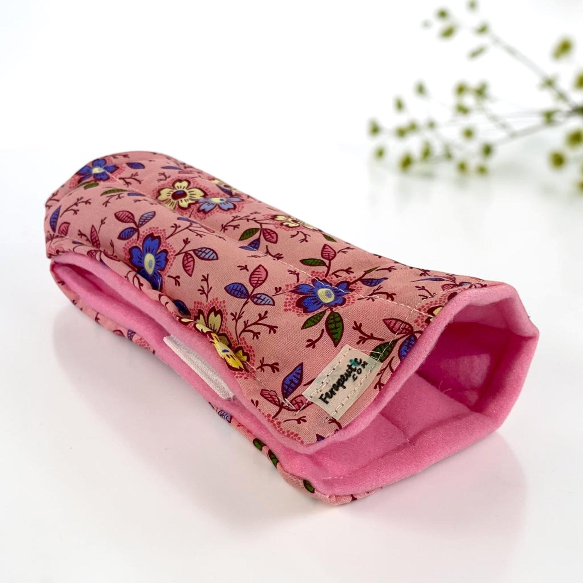 Slip on hot or cold wrist wrap for right or left hand in pink floral fabric.  Wrist wrap is divided into six even sections and filled with rice and flax seed.  