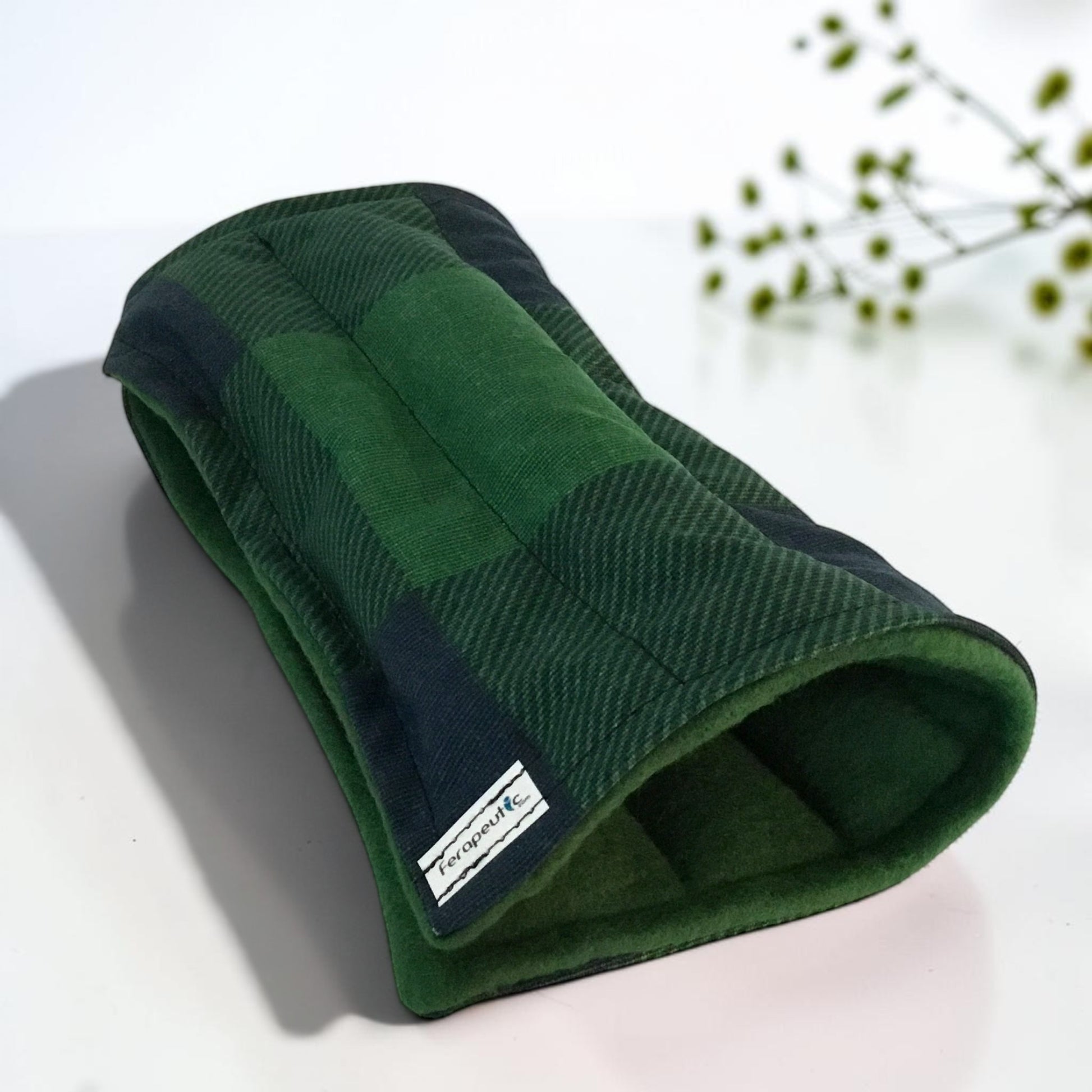 A green and navy plaid wrist wrap to be used hot or cold.  Six sections and appropriate for man or woman.